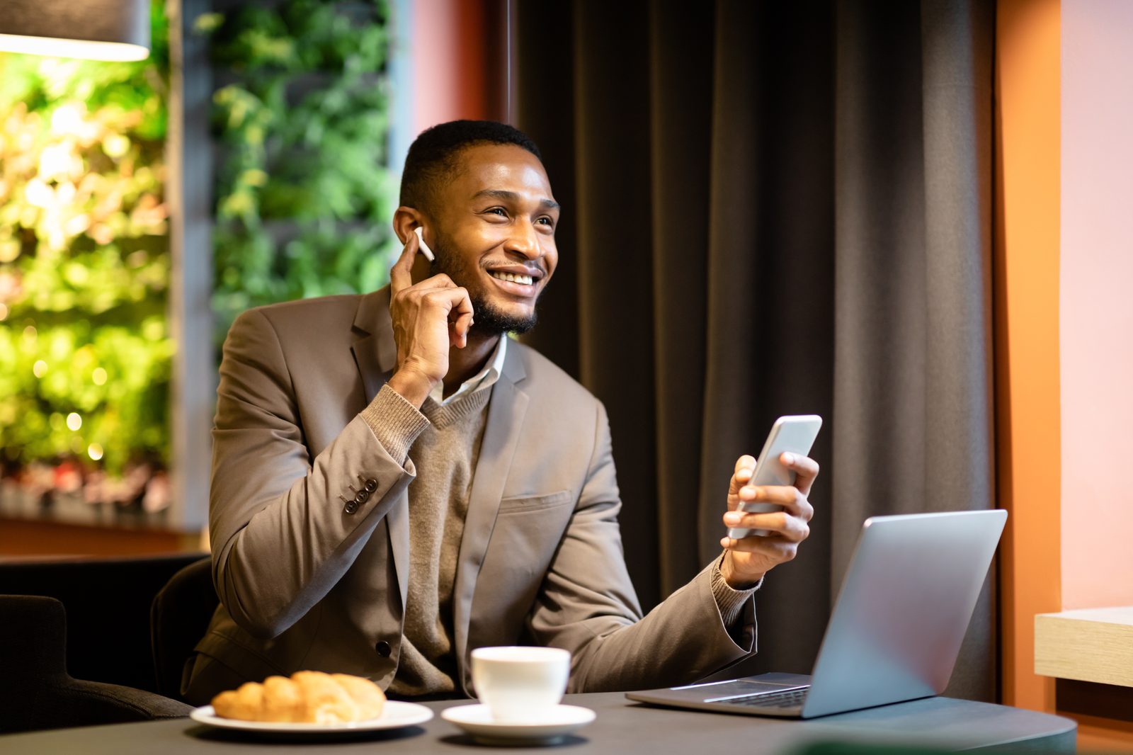 Someone taking a call with a laptop open in front of them